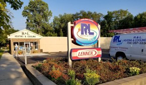 R&L Heating and Cooling sign and truck in front of our storefront in Taylor